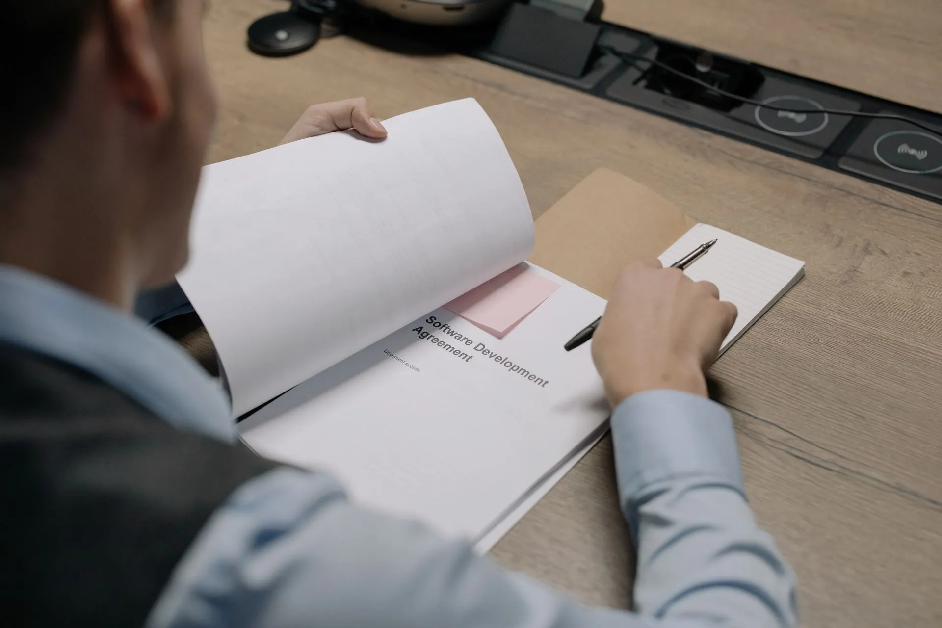 Man sitting at thedesk and looking in decument