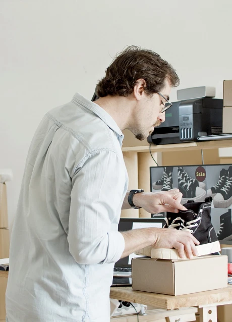 Business operator preparing an ecommerce order using product and inventory information