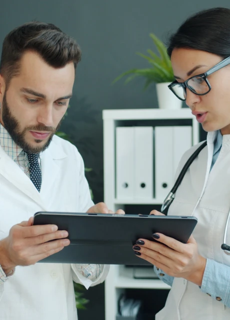 Healthcare professionals reviewing information on a tablet