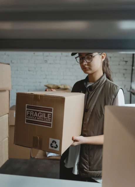 Worker handling a shipment box inside a delivery vehicle