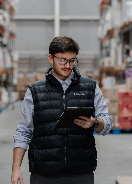 Warehouse professional reviewing operational information on a tablet