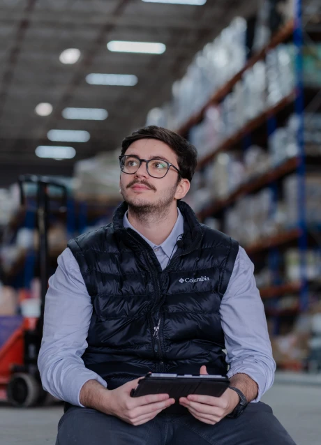 Warehouse professional using a tablet to manage operations in a distribution facility
