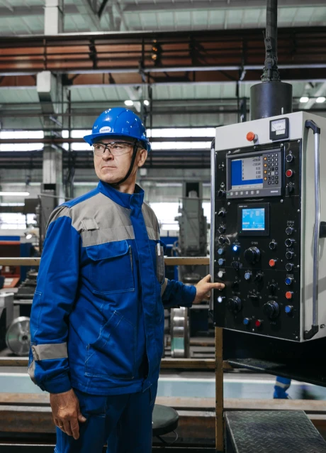 Manufacturing worker monitoring production operations on digital dashboards