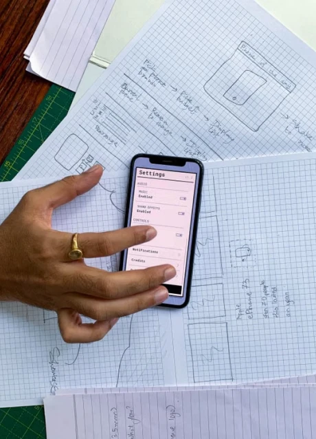 Mobile app interface sketch being reviewed during product planning