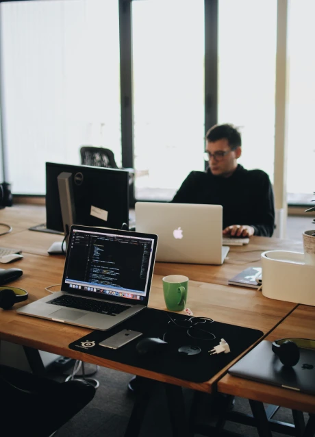 Developers working with software code on laptops