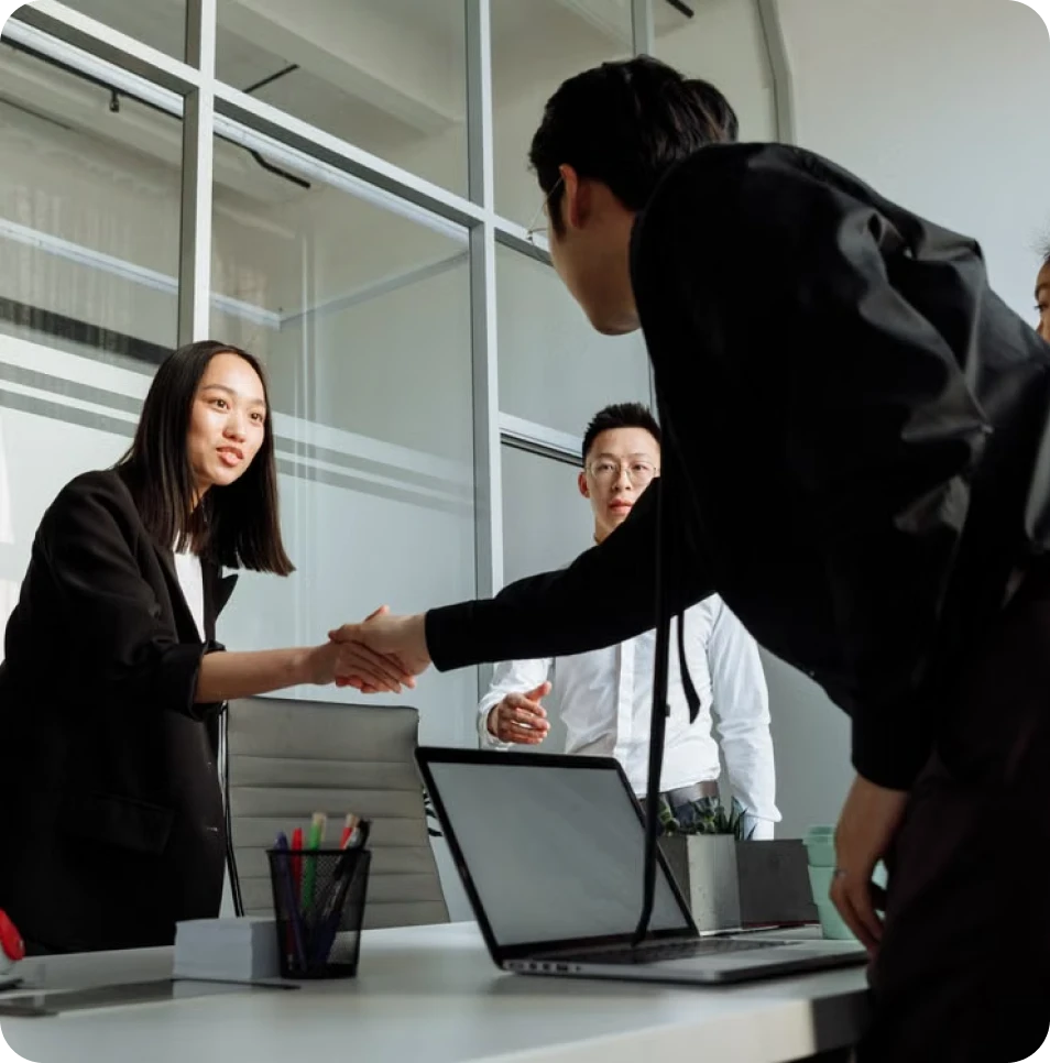Business professionals shaking hands during an office meeting