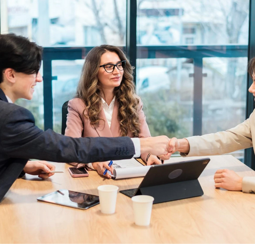 Business professionals shaking hands during a meeting