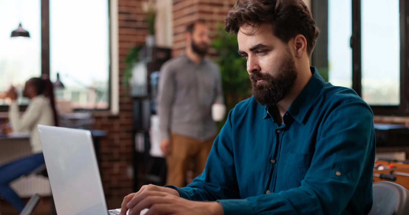 Developer working at a laptop in an office