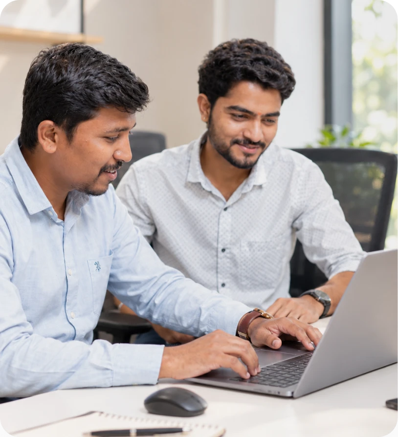 Two professionals working together on a laptop