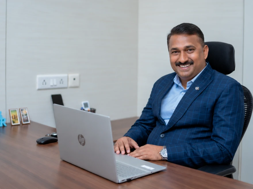Man working on a laptop at his desk in an office