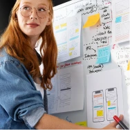 Professional reviewing software plans on a wall