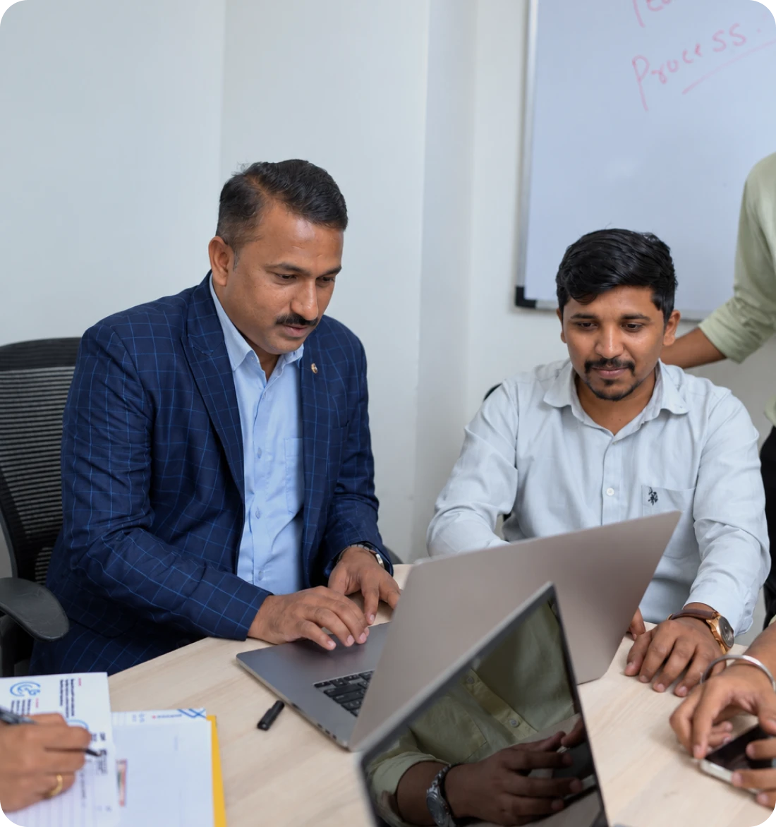 Professionals reviewing work together on a laptop